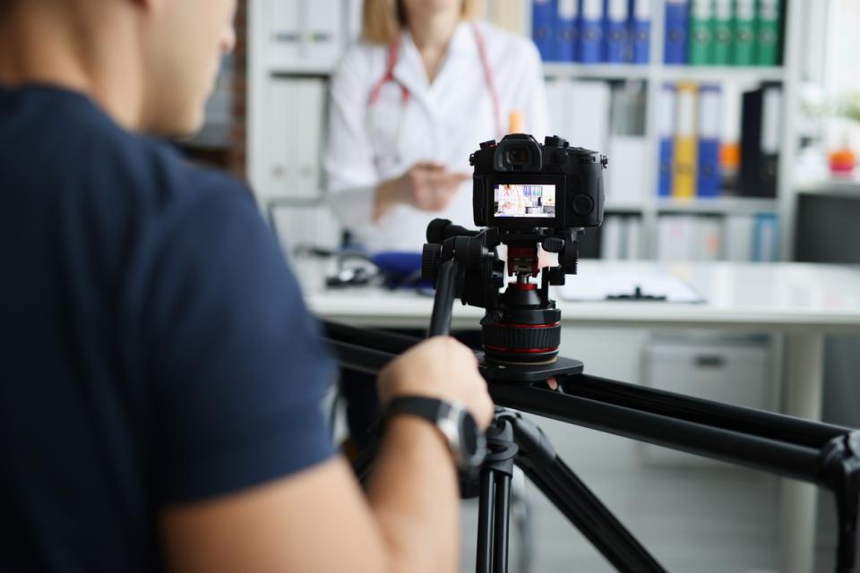 Close up of a camera as it films an instructor explaining a medical concept