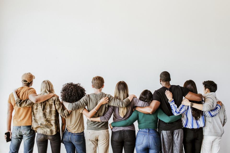 Students with their arms around each other from behind