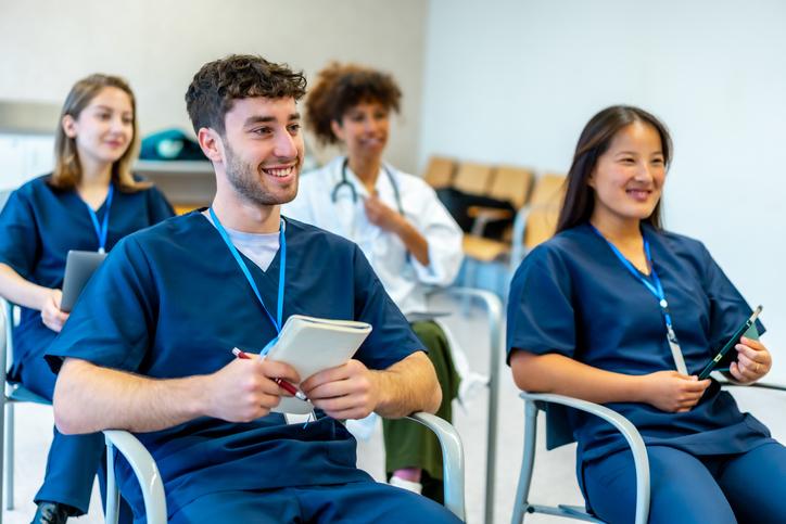 Medical students learn in a small session