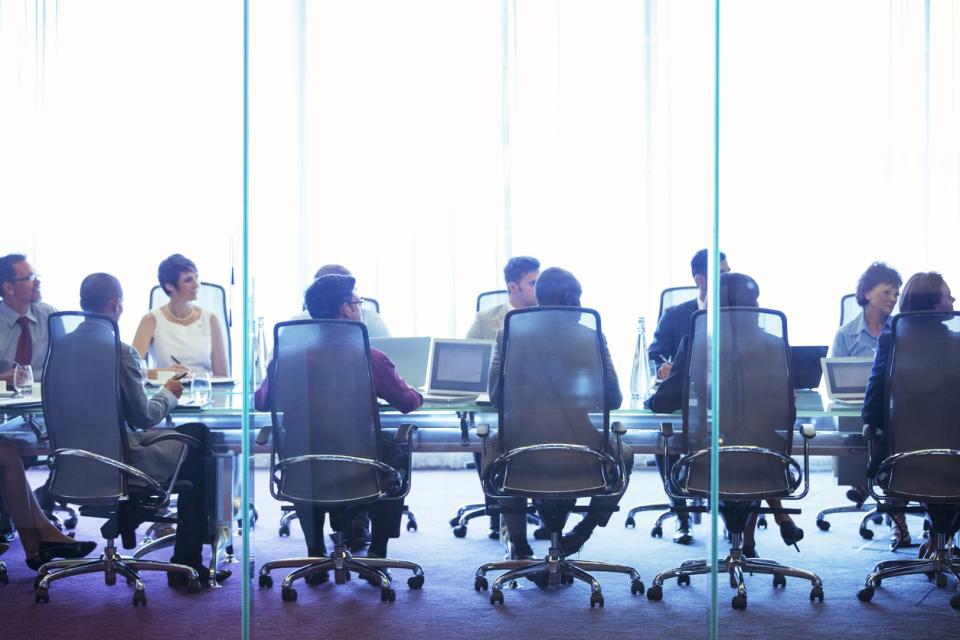 A team sat around a boardroom table