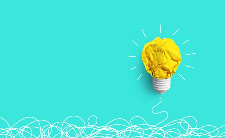 A scrunched-up piece of paper is fashioned into a lightbulb