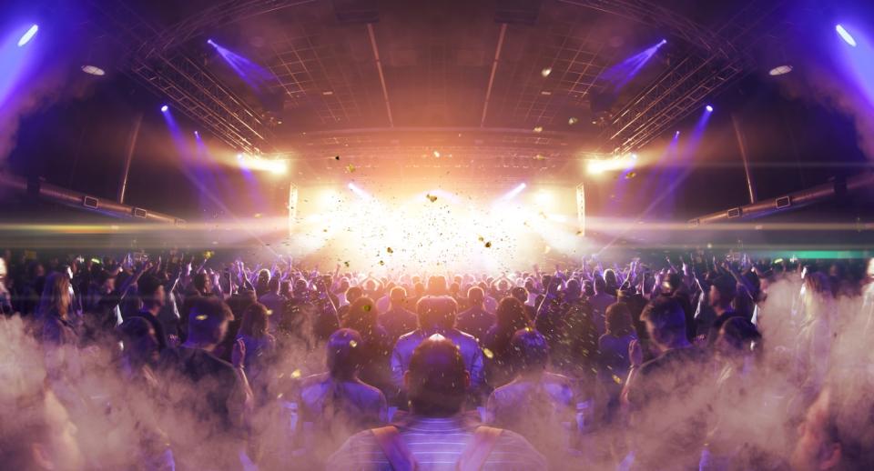 A concert crowd and strobe-lit stage