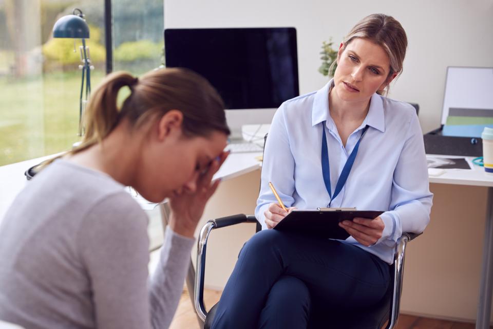 A teacher helping a student with mental health issues