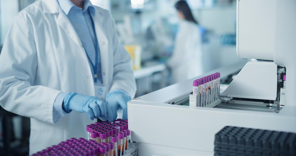 A researcher in a lab sorting test tubes