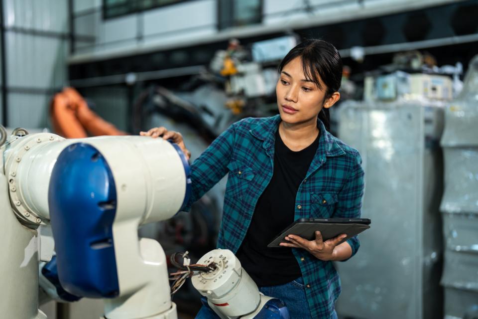 A woman building a robot