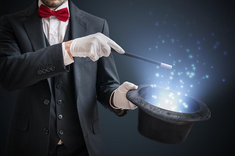 Magician conjuring magic out of a hat
