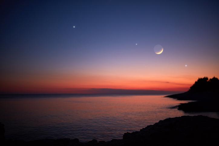 A moonlit sky with faraway stars