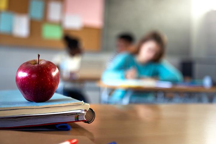 An apple on a classroom desk
