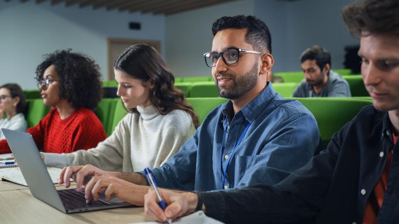 A student uses a laptop in a lecture hall