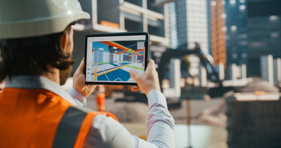 Industrial engineer inspecting a residential construction project with a VR app with a virtualisation of the building's interior