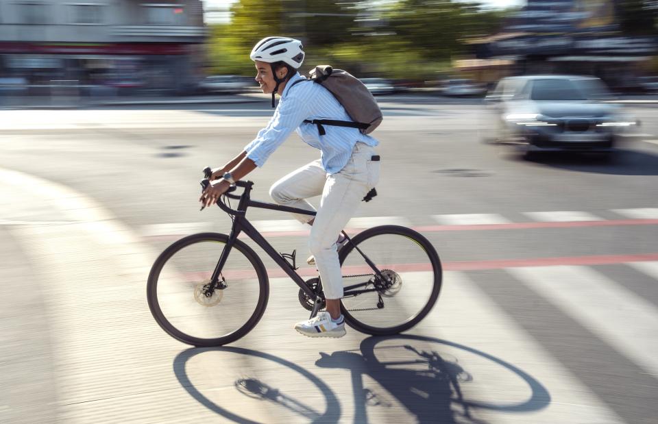 A cyclist riding down a quiet city road