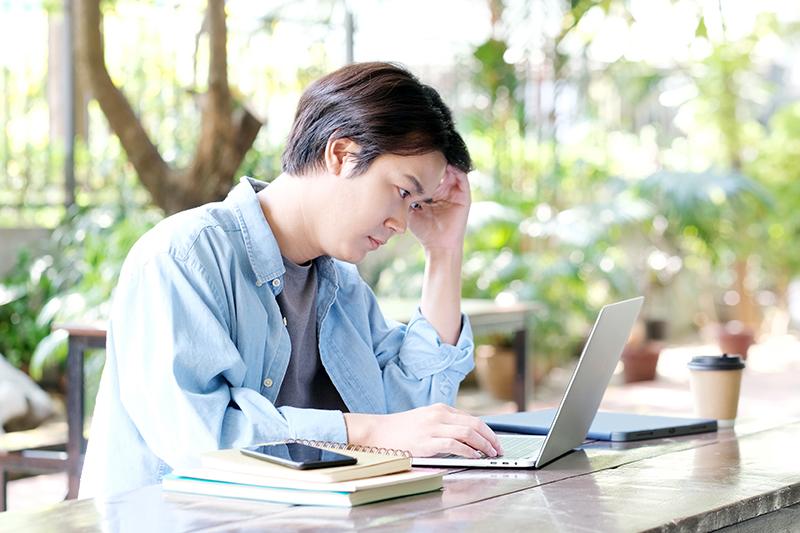 Asian student concentrating at a laptop