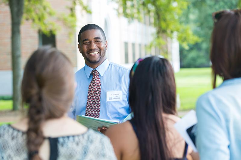 Tour guide showing potential students around university campus