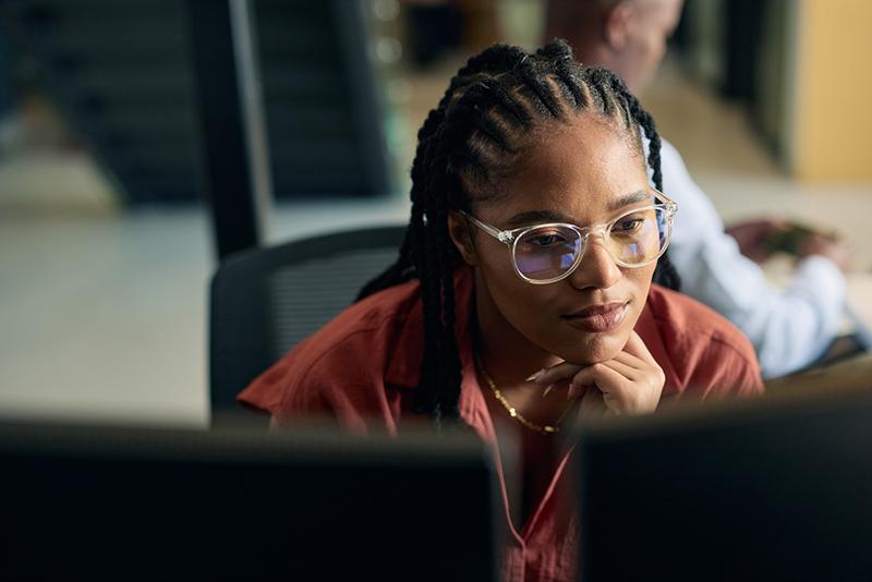 Black female professional working at computer