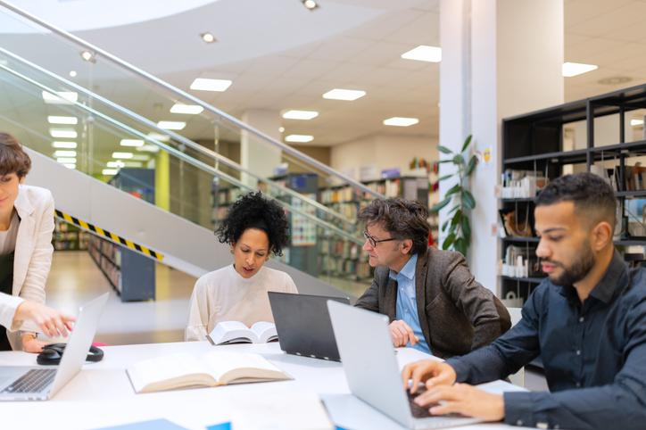 Research staff in a library working on a digital huimanities project