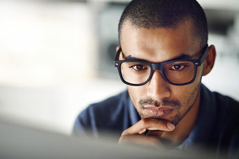 Young man looking at laptop