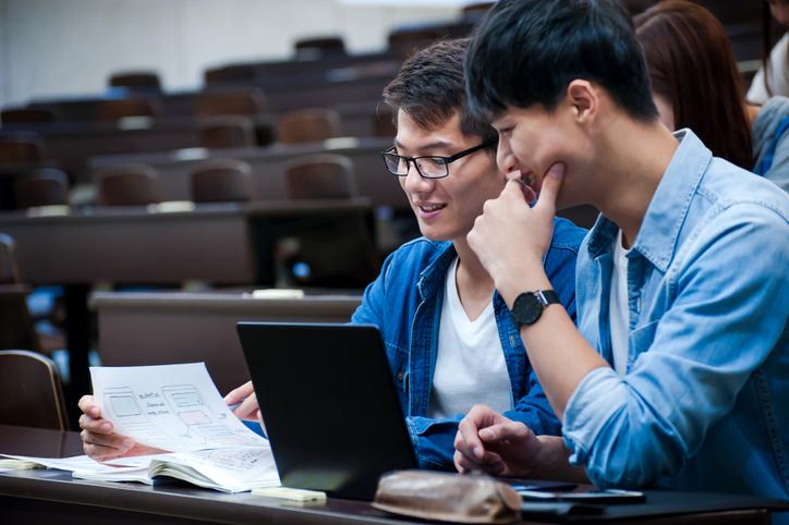 Chinese students working together at a laptop