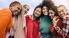 Group of young women embracing and smiling at the camera