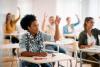 Student raising hand in class