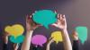 Speech bubbles being held above unseen person's head