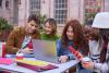 Students work together over a laptop