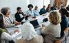 Employees sitting at a long table in a boardroom