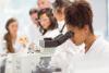 A student uses a microscope in a lab