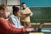 A teacher works with students on GenAI literacy