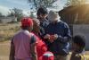 Group of people in Kenya, looking at a mobile phone