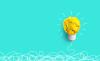 A scrunched-up piece of paper is fashioned into a lightbulb