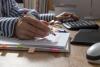 A reviewer wields a red pen