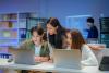 Students work together over a laptop