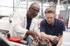 Older engineer working with an engineering apprentice