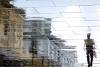 Distorted reflection of a man walking in the street
