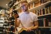 A student looks up from a book to check his smartphone 