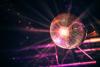 A disco ball suspended from the ceiling of a dimly lit room