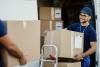 A delivery driver carrying a box 