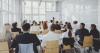 A talk in a large windowed room