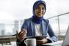 A woman wearing a headscarf in an office