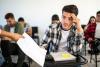 An unenthused student receives a test back in the classroom