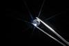 A diamond held by tweezers