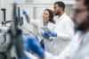Two lab workers discussing something on a screen