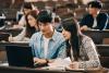 Asian students doing pair work in a lecture hall